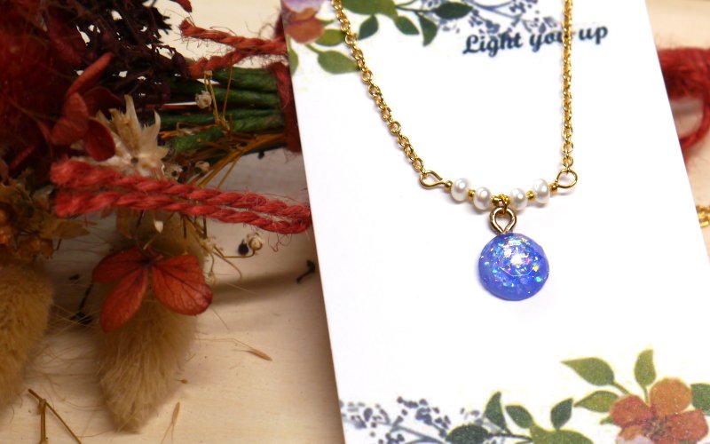 Small cosmic necklace SL327 in the eye