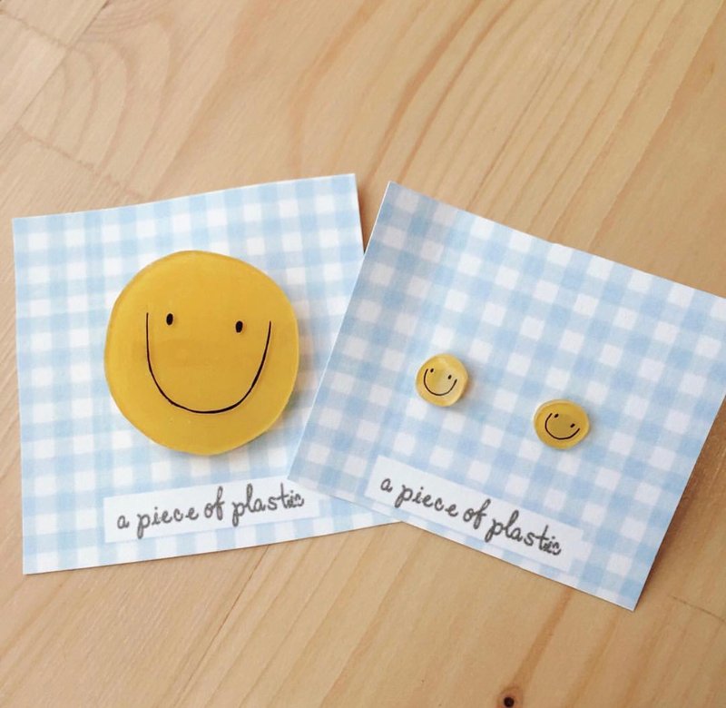 Seth brooch and smiley face earrings
