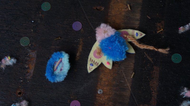 Embroidered blue yellow moth with asymmetrical ear clips