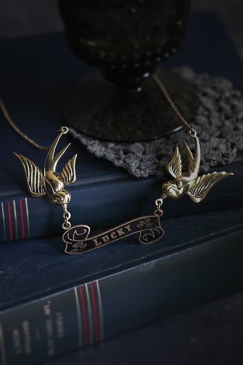 defy The Swallows with Lucky Ribbon Necklace by Defy.