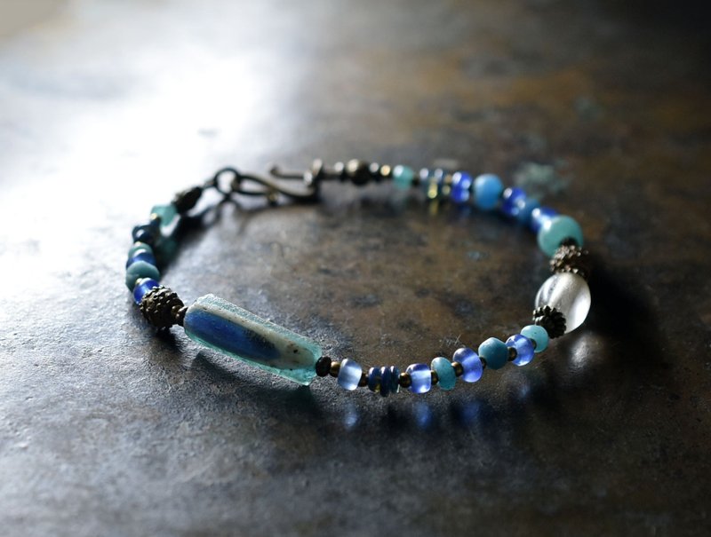 Bracelet made of eye-patterned Roman glass, antique Bohemian beads, brass beads, opals, and colorful blue beads. - Bracelets - Glass Blue