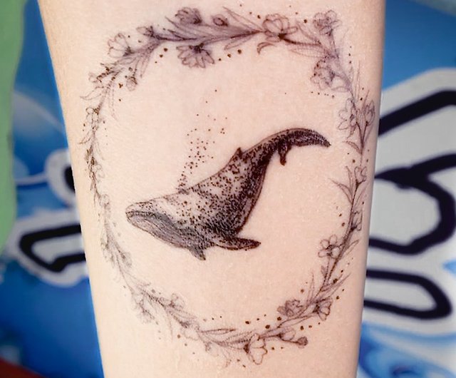 Microrealistic wave and swallow tattoo on the tricep