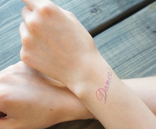 Be free lettering tattoo on the wrist