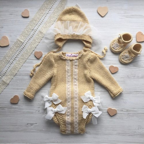 V.I.Angel Hand knit beige romper, hat and booties for baby girl.