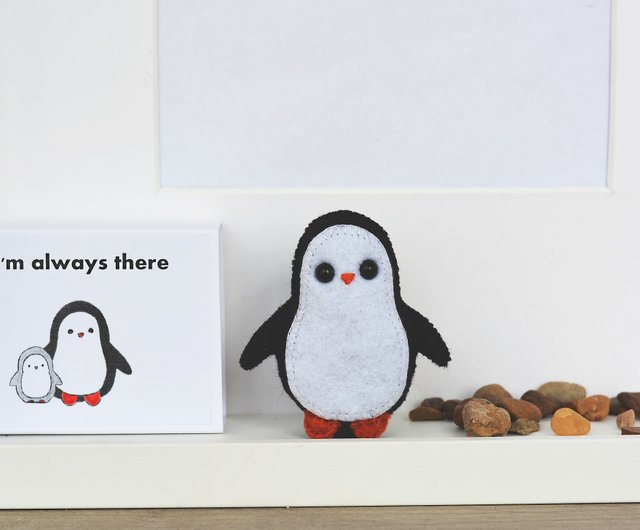 A cute little penguin folded from a washcloth and a small rubber