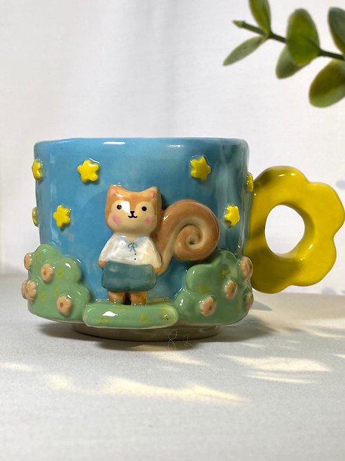 cher’s pottery Handmade ceramic mug with a cute little squirrel design.
