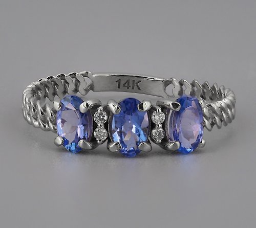 Daizy Jewellery 14 k gold ring with 3 tanzanites and diamonds.