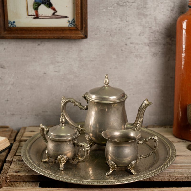 Vintage metal tea set consisting of a tea pot, sugar bowl and creamer