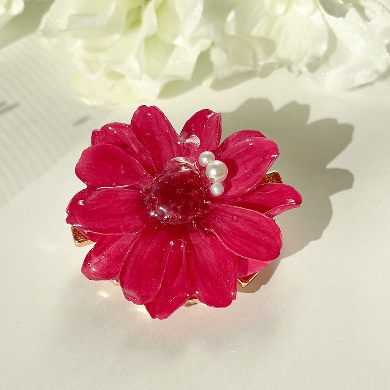 The magenta zinnia flower is a gorgeous brooch.