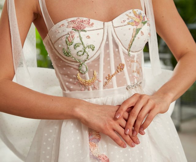 Asymmetrical short bridal dress with train. Embroidered corset