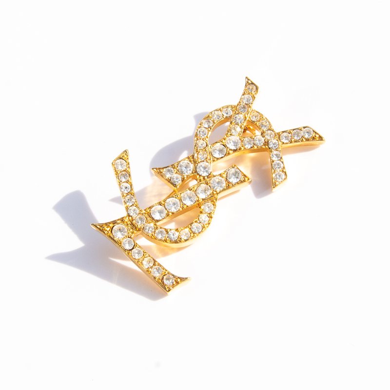 80s Yves Saint Laurent Vintage gold tone rhinestone logo brooch - Brooches - Other Materials Gold