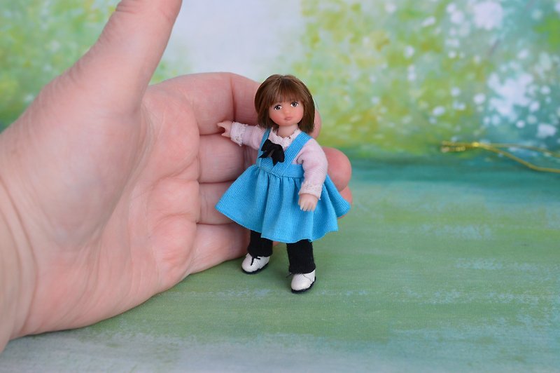 Miniature doll child in 12th scales.