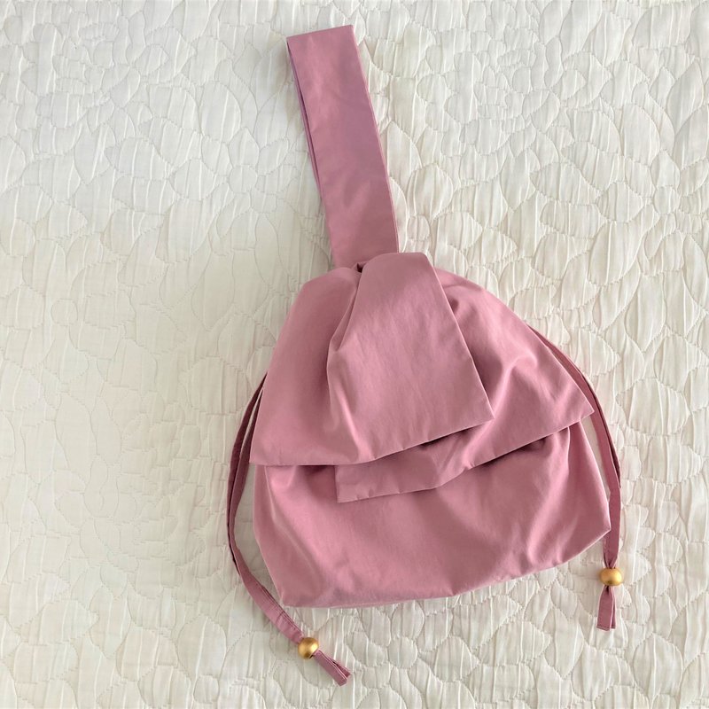 Water repellent taffeta big ribbon one handle drawstring mini bag smoky pink - กระเป๋าถือ - วัสดุอื่นๆ สึชมพู