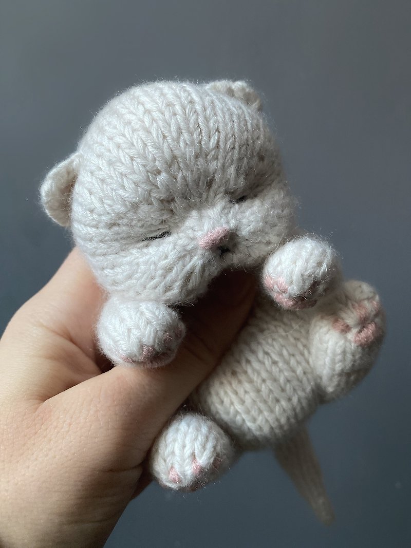 Toy knitted sleeping newborn kitten, safe toy for baby