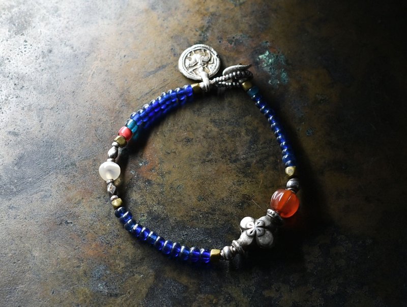 A bracelet made of old Himachal Silver, vintage tangerine balls, carnelian, ancient agate, old Orissa brass and tin Silver, blue beads, and old Indian Silver charms. - Bracelets - Glass Blue