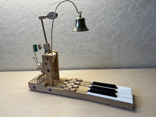 New Life Retro A table bell made of the keys and hammer of an old piano and an antique brass be