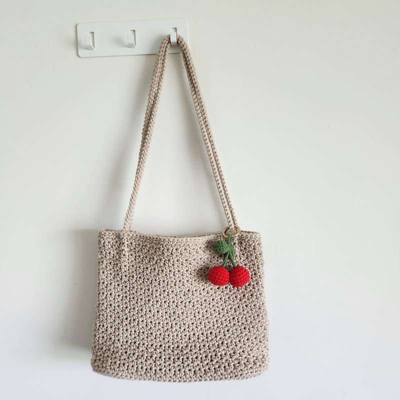 JOAN's work- Khaki round strand cotton side backpack with small cherry pendant - กระเป๋าแมสเซนเจอร์ - ผ้าฝ้าย/ผ้าลินิน สีกากี