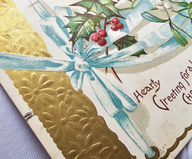 ブルーのウェディングリボンエンボスヒイラギクリスマスグリーティング