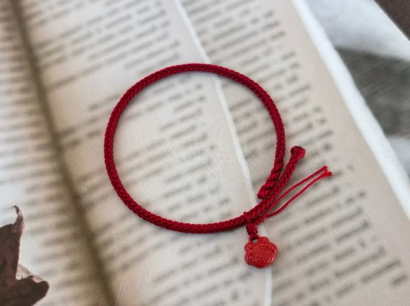 Red String Bracelet with Cinnabar Beads and Lotus Tassel - สร้อยข้อมือ - เครื่องเพชรพลอย สีแดง