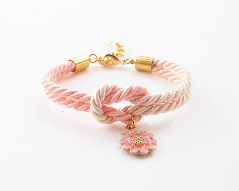 Peach and ivory cream knot rope bracelet with peach flower charm - สร้อยข้อมือ - วัสดุอื่นๆ สีส้ม