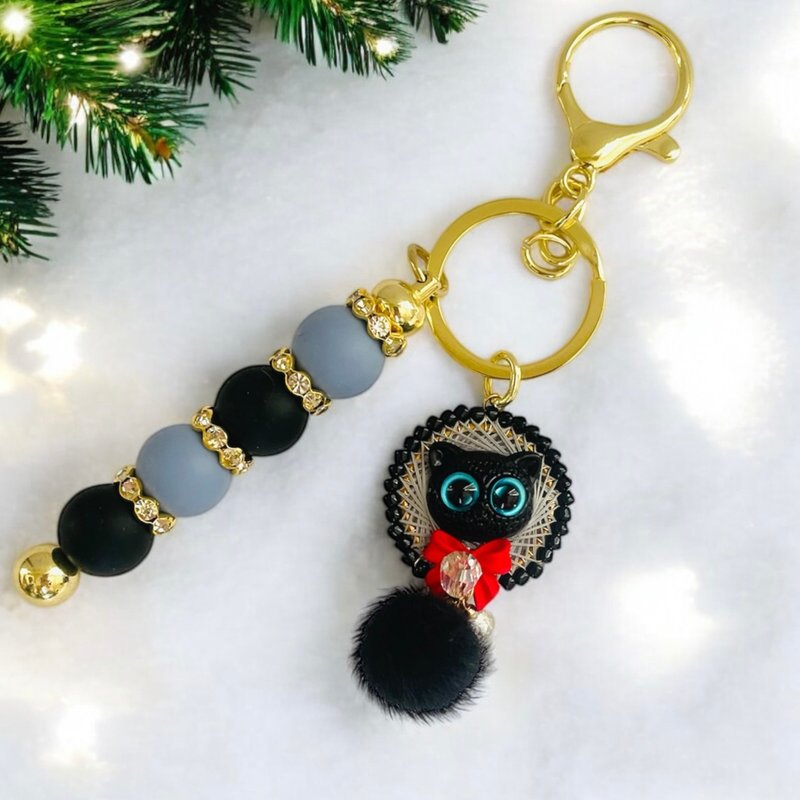 A magical blue-eyed black cat walking in the mysterious night sky and a red ribb - Keychains - Thread Black