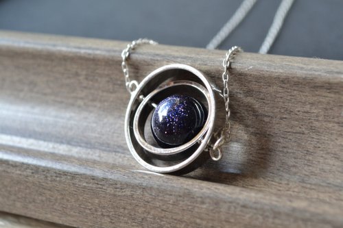 Spinning little planet with Goldstone necklace