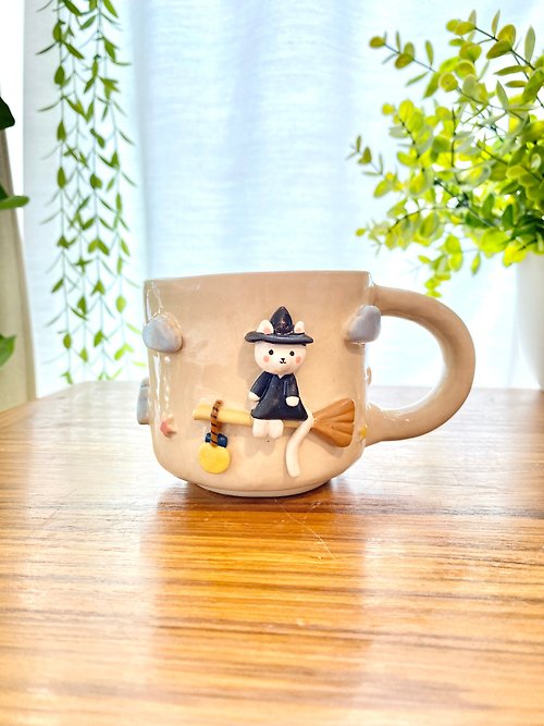 cher’s pottery Handmade ceramic mug with witch cat design and a super cute magic broom