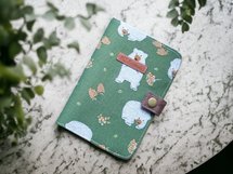 Handmade passport cover. Big brown bear on the grass