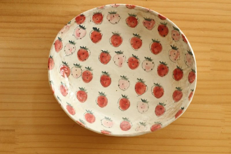 Olive dish full of dusting strawberries.