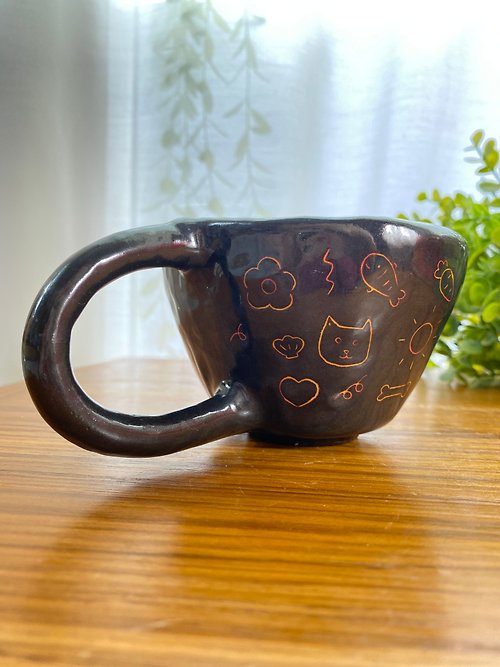 cher’s pottery Handmade ceramic mug with a cute cat drawing.