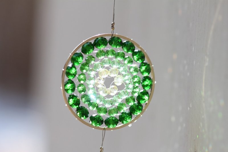 A shining green color mandala made of glass beads. - Other - Glass Green