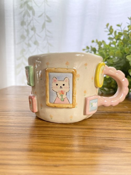 cher’s pottery Handmade ceramic mug with cute cat and flower lover drawings.