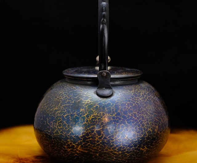 A close-up of a handcrafted Japanese teapot, placed centrally on an old  wooden table. There are steam tendrils rising from the spout, suggesting a  freshly made hot brew. 28781778 Stock Photo at