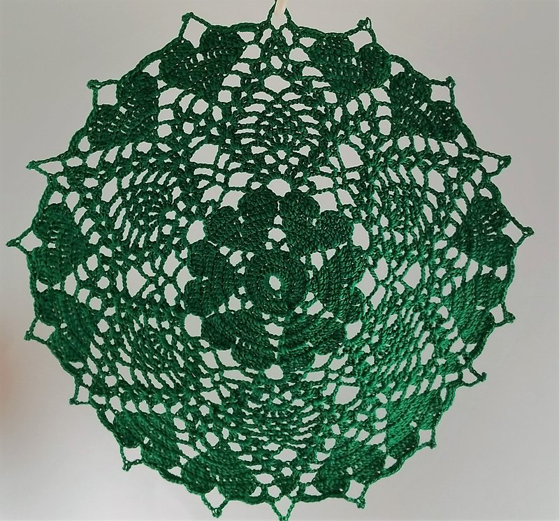 Set of two small green crocheted transparent lacy place mats for home decorating