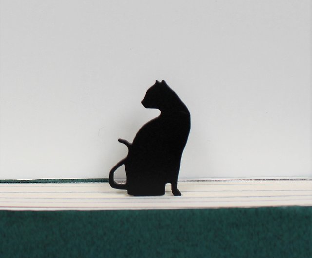 black cat reading a book