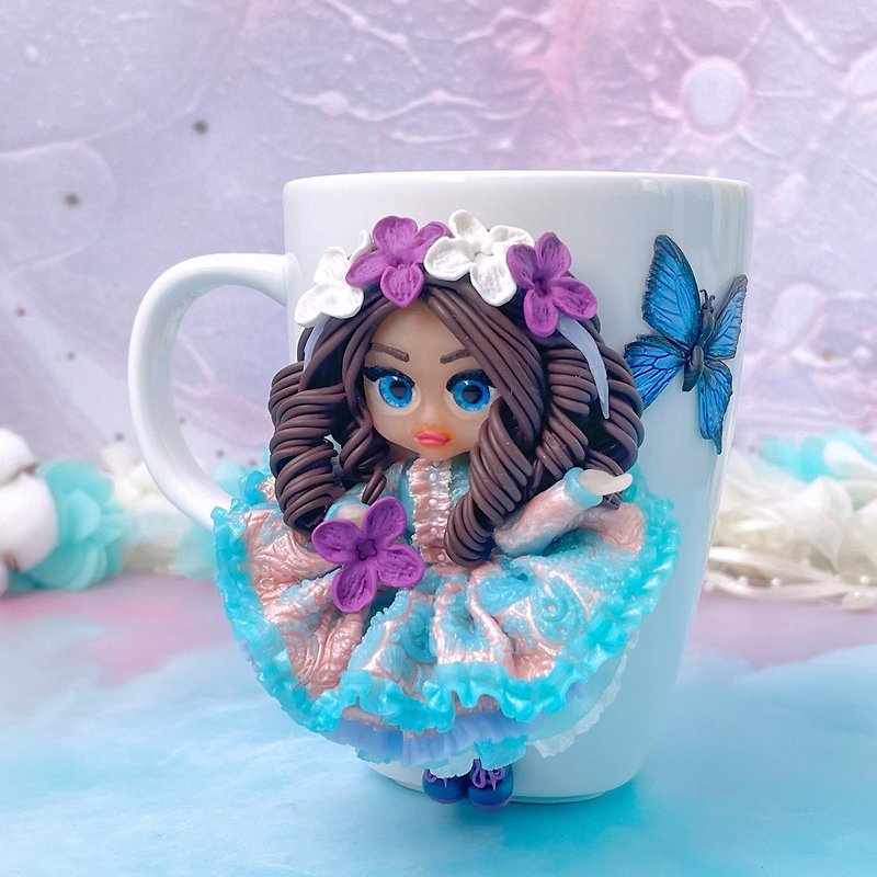 Cute mug with a polymer clay doll with lilac flowers and a blue butterfly. - Mugs - Clay Multicolor