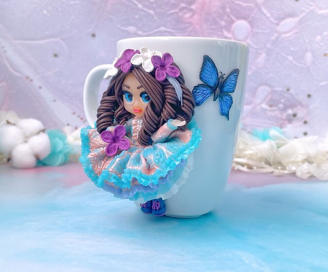 Cute mug with a polymer clay doll with lilac flowers and a blue