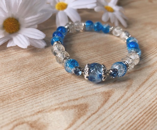 Pale blue string bracelet, clear and dark blue glass beads