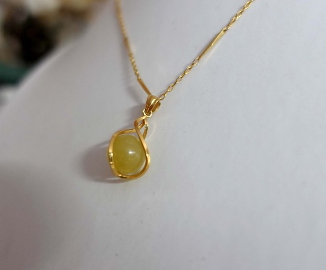 gold necklace with yellow stone